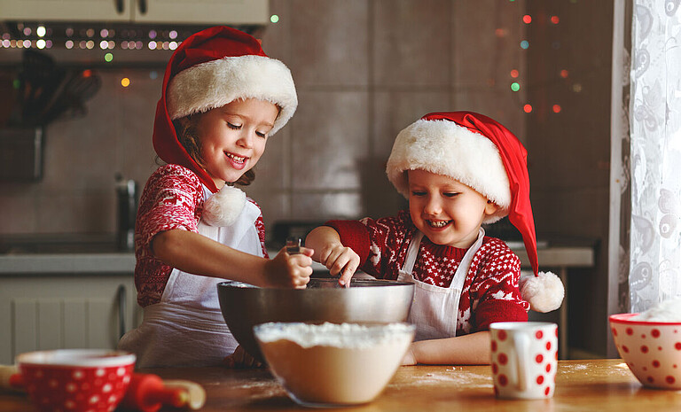 happy childran bake christmas cookies © JenkoAtaman - Adobe Stock